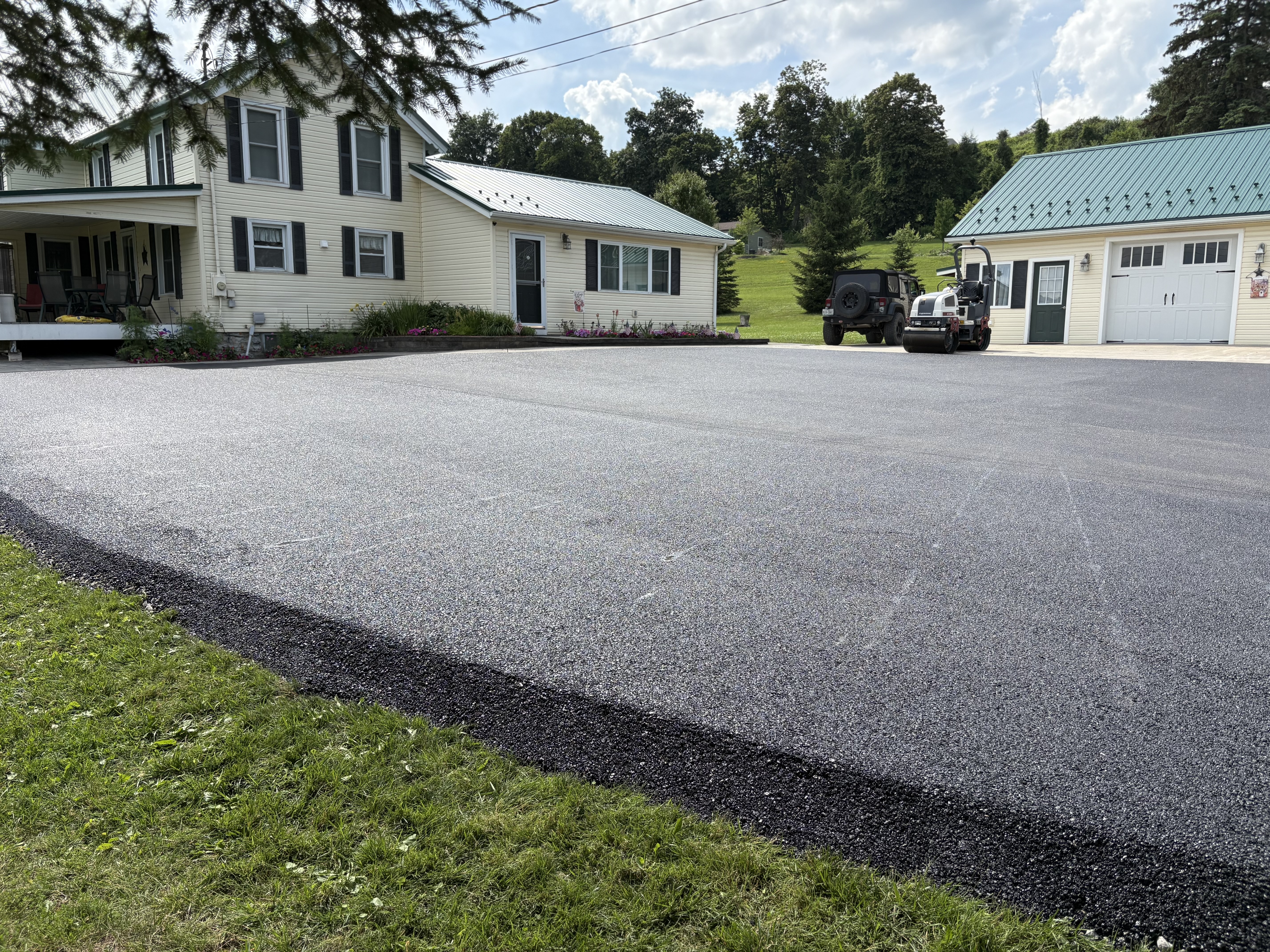 Freshly paved residential surface with houses and garage by Capital Paving in Brighton, Michigan
