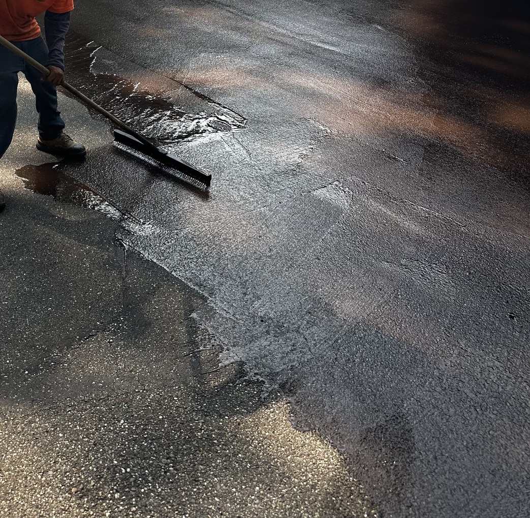 Wide asphalt lot protected with professional seal coating